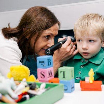 A clinician works with a child at the UQ Audiology clinic.